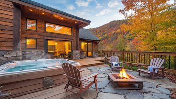 Luxury mountain cabin with hot tub, fire pit, and scenic autumn forest views on a spacious outdoor deck